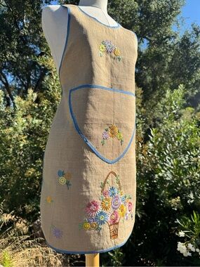 Vintage handmade embroidered apron floral design with blue trim